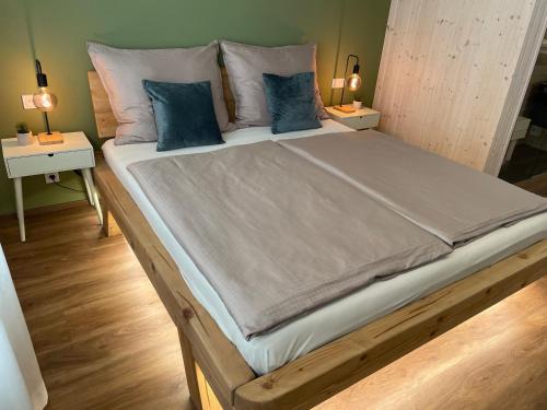 a large bed with blue pillows in a bedroom at Golden Key Apartments in Liberec