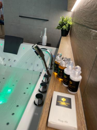 a bathroom with a sink and a bath tub with a book at Golden Key Apartments in Liberec
