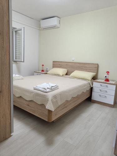 a bedroom with a large bed with two towels on it at Apartments Vukas in Lumbarda