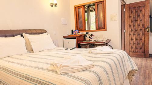 Cama o camas de una habitación en Pousada Medeiros