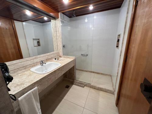 a bathroom with a sink and a shower at Hotel Atlante Plaza in Recife