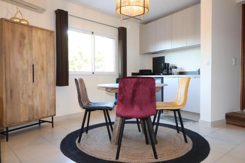 a kitchen with a table and two chairs at Appartement 50 m2 avec parking gratuit sur place in Vailhauquès