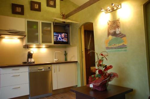 a kitchen with a counter and a tv on the wall at B&B Val D'azur in Carqueiranne