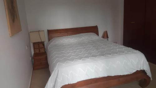 a bedroom with a large white bed in a room at Marina dore in Sidi Yahia az Zaʼer
