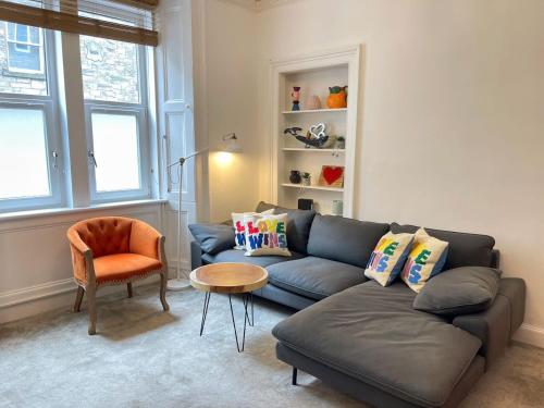 a living room with a couch and a chair at Lovely two bedrooms in Edinburgh