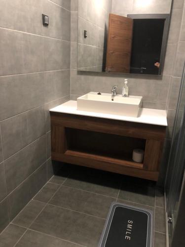 a bathroom with a white sink and a mirror at Apartmani Baumid Apatin in Apatin