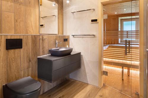 a bathroom with a sink and a toilet and a shower at Skylodges in Oberried