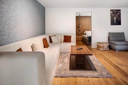 a living room with a white couch and a table at Skylodges in Oberried