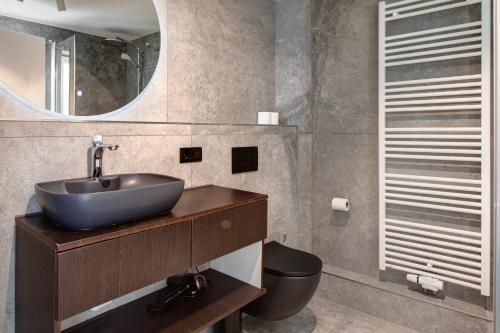 a bathroom with a sink and a toilet at Skylodges in Oberried