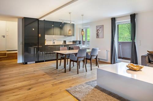 a kitchen and living room with a table and chairs at Skylodges in Oberried