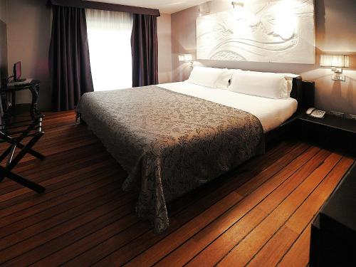 En eller flere senger på et rom på Borghese Palace Art Hotel