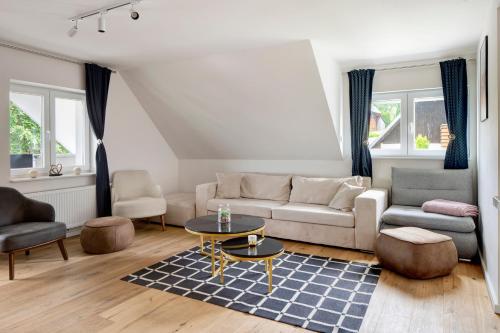 a living room with a couch and a table at Skylodges in Oberried