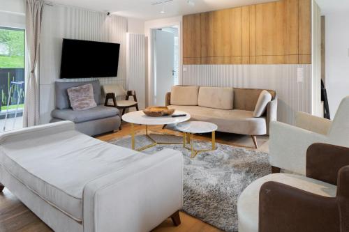 a living room with a couch and a table at Skylodges in Oberried