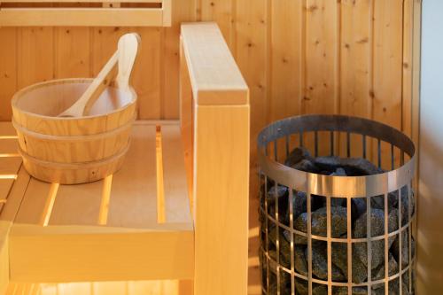 a bathroom with a tub and a trash can next to a bench at Skylodges in Oberried