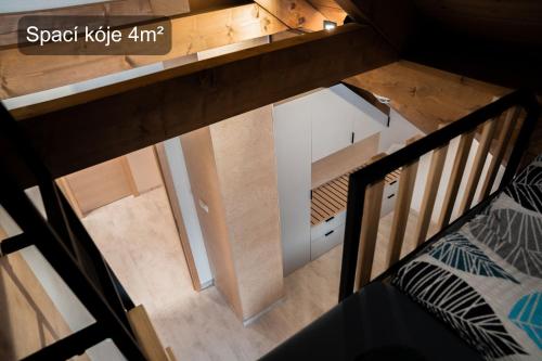 an overhead view of a room with a bed and a staircase at Chata Točník in Bělá pod Pradědem