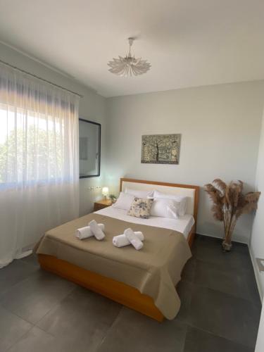 a bedroom with a bed with two towels on it at Dimis cozy villa near the sea! in Litochoro