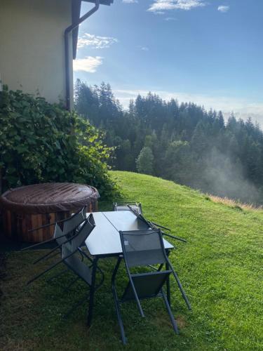 a picnic table and chairs sitting on the grass at Apartament w górach Gorce in Nowy Targ