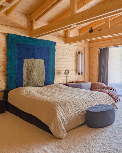 a bedroom with a large bed in a wooden room at Sami Mta Chalet in Mestia
