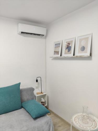 a white living room with a couch and a table at Harmony House in Oradea