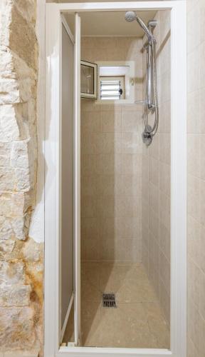 a shower with a glass door in a bathroom at La Piccola Dimora in Giovinazzo