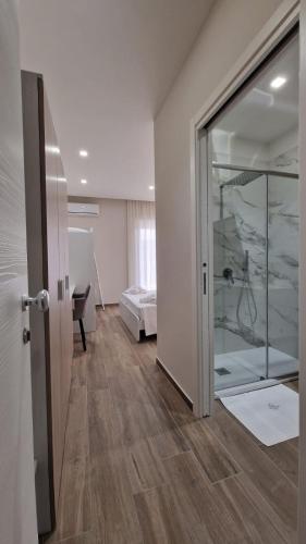 a room with a sliding glass door and a bedroom at ARIA DI MARE LUXURY B&B in Schiavonea