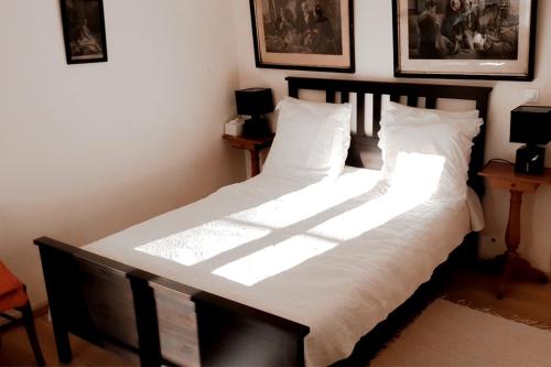 une chambre avec un grand lit avec des draps blancs dans l'établissement La vie de château à Orgeval - Chambre Feydeau, à Orgeval