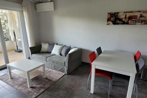 un salon avec un canapé, une table et des chaises dans l'établissement Family apartment 2 Rooms in Antibes, à Antibes
