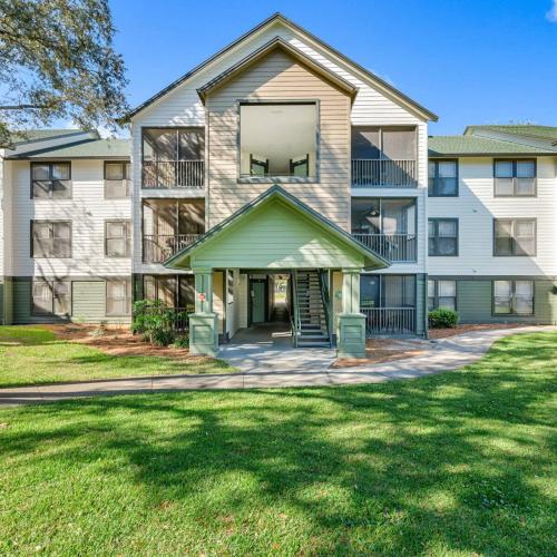 an apartment building with a lawn in front of it at Family home near USF in Tampa