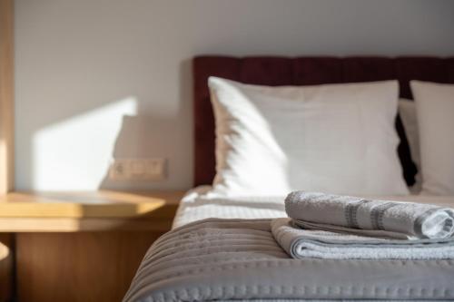 a stack of towels sitting on top of a bed at Elena's Luxury Sea View House 3 in Neos Marmaras