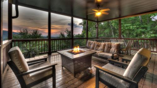 a screened in porch with a couch and a table at An Owl's Perch in Morganton