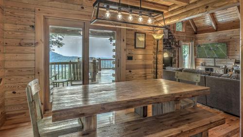 a dining room with a wooden table in a cabin at An Owl's Perch in Morganton