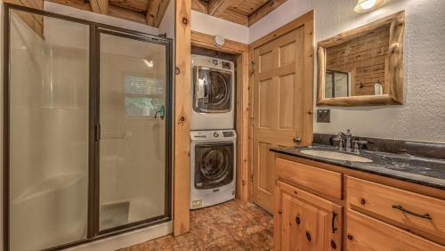 a bathroom with a washer and dryer and a sink at An Owl's Perch in Morganton