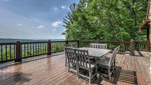 a wooden deck with a table and chairs on it at An Owl's Perch in Morganton