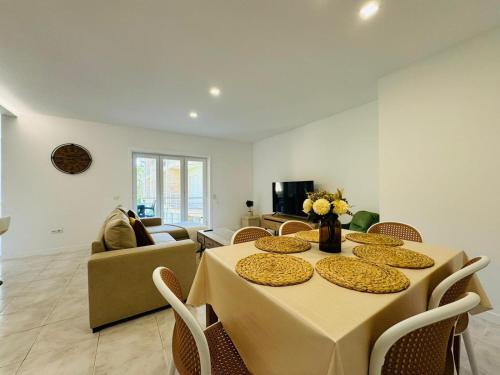 a dining room with a table and chairs and a couch at Casa Valérie in Esposende