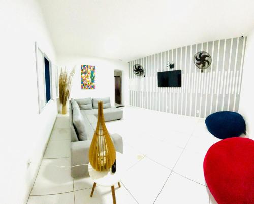 a living room with a couch and a tv at Hostel Recanto da Paciência in Salvador