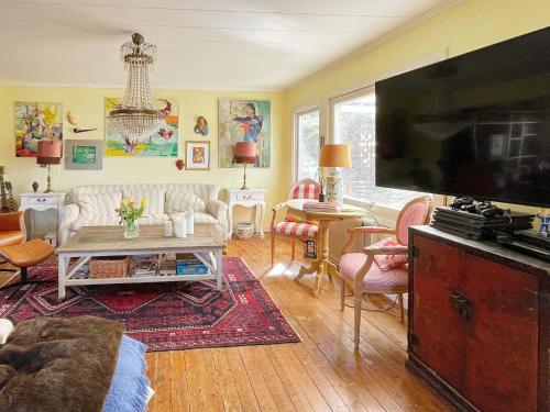 a living room with a large flat screen tv at 8 person holiday home in KLÖVEDAL-By Traum in Klövedal