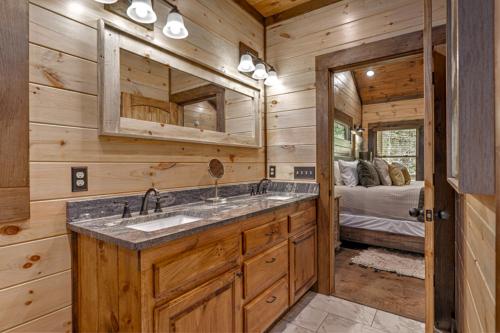 a bathroom with a sink and a bedroom with a bed at Friends in High Places in Blue Ridge