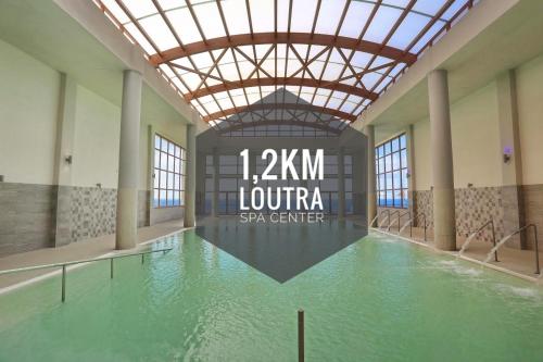 a large pool of water in a building with a ceiling at LOUTRA VILLAS in Agia Paraskevi