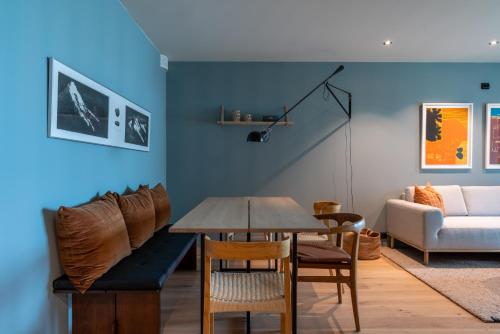 a living room with a table and chairs and a couch at Modern Apartment close to Leknes in Leknes
