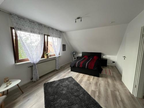 a living room with a black couch and a window at Ferienwohnung Kleine Auszeit in Ascheberg