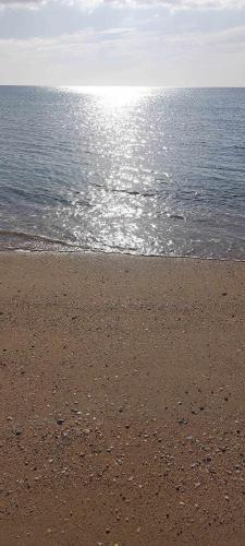 a sandy beach with the ocean in the background at Appartement Marina Beach, Mdiq in M'diq