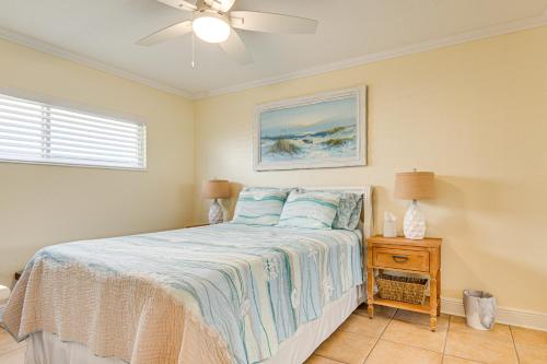 a bedroom with a bed and a ceiling fan at Cute Cocoa Beach Condo with Pool and Beach Access! in Cocoa Beach