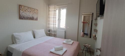 a bedroom with a bed with two towels on it at Christos in Kissamos