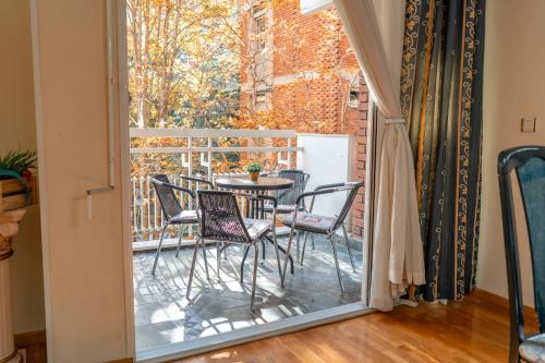 a patio with a table and chairs on a balcony at Favorite Family & Dining Gem in Skopje in Skopje
