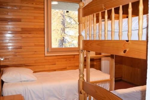 une chambre avec deux lits superposés et une fenêtre dans l'établissement Chalet Boulevard - Chalet Boulevard -8 pers - PLAGNE CENTRE, sur les pistes - wifi MAE-6814, à Aime La Plagne