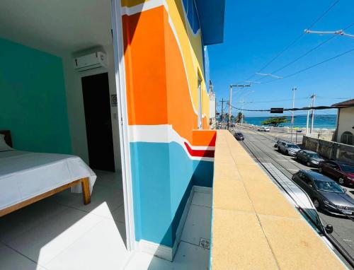 a balcony with a bed and a view of a street at Hostel Recanto da Paciência in Salvador
