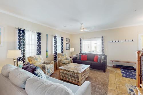 a living room with a couch and a table at Corals and Oars in Myrtle Beach