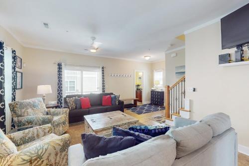 a living room with a couch and a table at Corals and Oars in Myrtle Beach