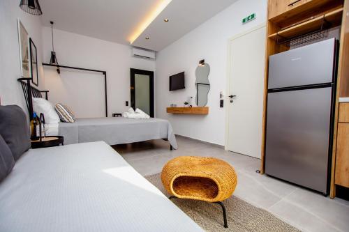 a bedroom with a bed and a room with a door at LA PLAZA luxury suites NEA VRASNA in Nea Vrasna