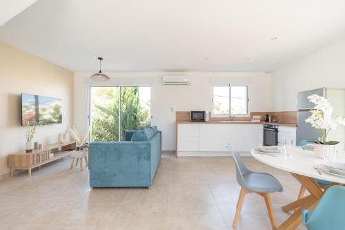 a kitchen and living room with a table and chairs at Villa Thym in Marignane